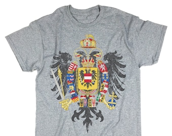 May include: A heather grey t-shirt with a distressed vintage design of the coat of arms of the Holy Roman Empire. The coat of arms features a black double-headed eagle with a shield on its chest.