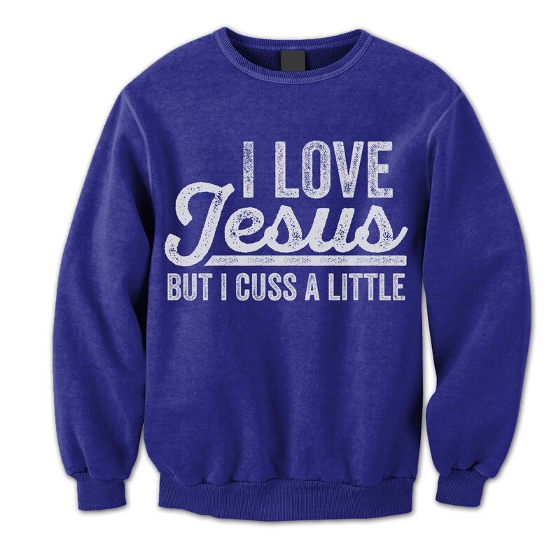 May include: A royal blue long-sleeved sweatshirt with a white distressed graphic that reads "I love Jesus but I cuss a little."