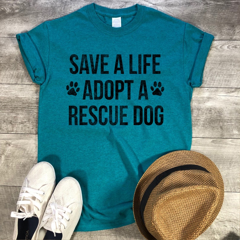 May include: Teal blue t-shirt with the text "Save a Life Adopt a Rescue Dog" in black with paw prints on either side of the word "Adopt".