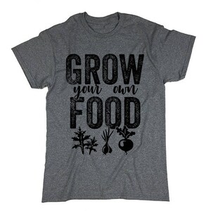 May include: Gray t-shirt with the text "Grow your own food" in black. The text has a distressed look. There are small black illustrations of vegetables below the text.