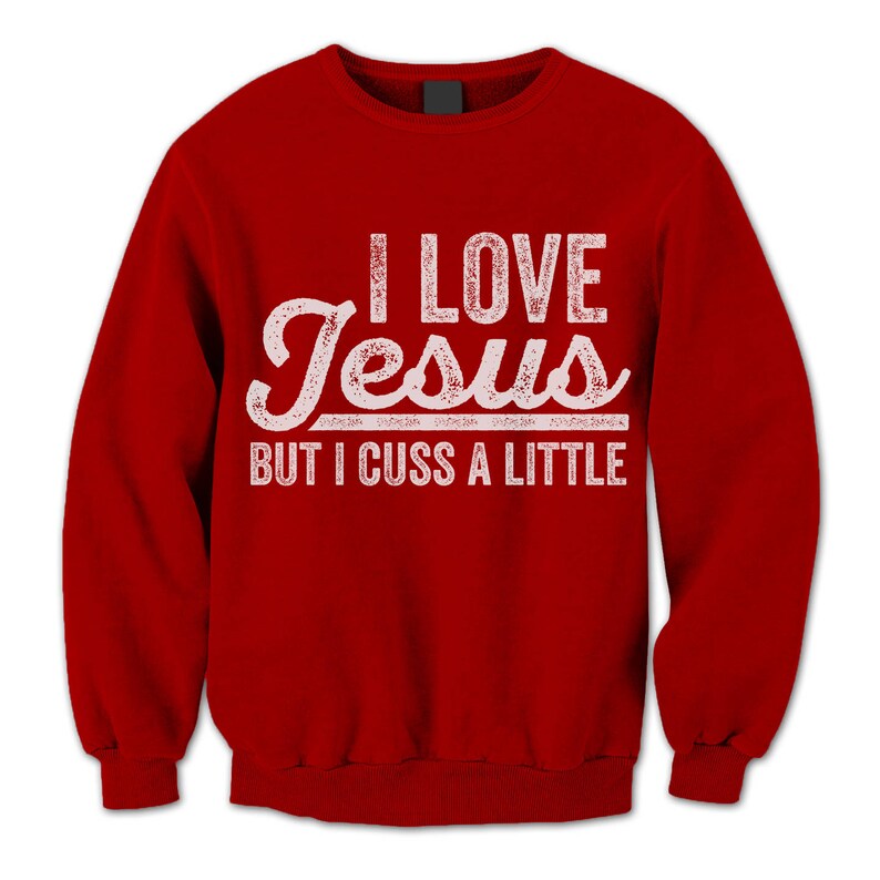 May include: Red sweatshirt with a white distressed graphic that says "I love Jesus but I cuss a little."
