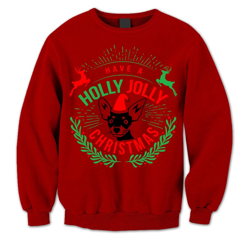 May include: Red Christmas jumper with a green and white wreath design. The wreath has the text "Have a Holly Jolly Christmas" and a black and white chihuahua wearing a red Santa hat in the centre.