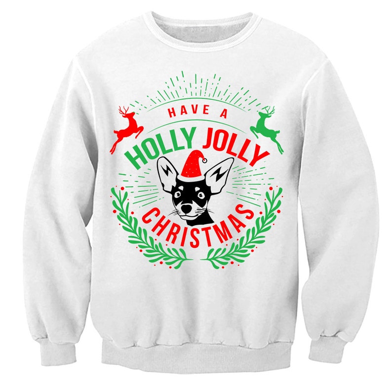 May include: White sweatshirt with a green and red Christmas design featuring a black and white dog wearing a Santa hat. The text reads "Have a Holly Jolly Christmas".