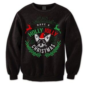 May include: Black sweatshirt with a green and red Christmas design featuring a dog wearing a Santa hat and the text "Have a Holly Jolly Christmas".