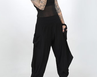 May include: Black, loose-fitting pants with a wide leg and a gathered detail at the ankle. The pants have a low rise and a wide waistband.