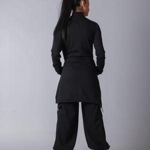 Soft black cotton sweatpants with loose fit and functional cargo pockets