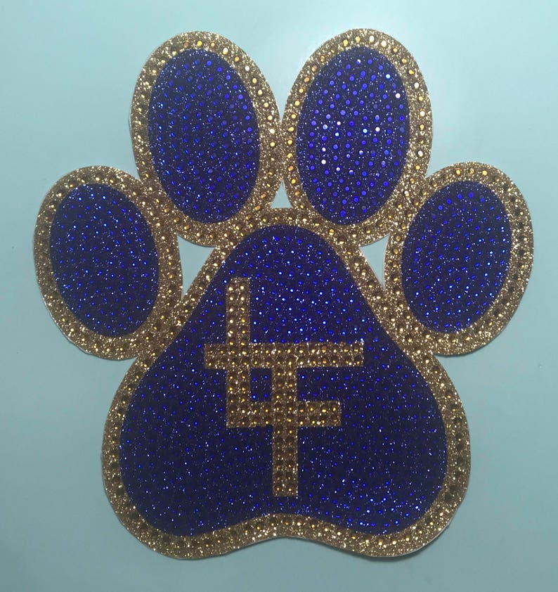 May include: A blue paw print with a gold outline and a gold "LF" in the center. The paw print is covered in glitter.