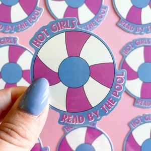 May include: A pink and blue life preserver sticker with the text "Hot Girls Read By The Pool" in a white outline.