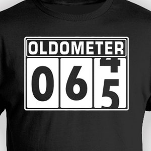 May include: Black t-shirt with a white graphic of a digital odometer reading "065".