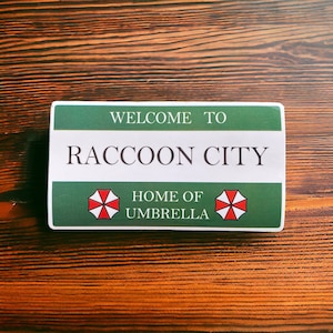 Welcome to Raccoon City Green Waterproof and UV resistant PVC sticker. Size 100mm x 55mm