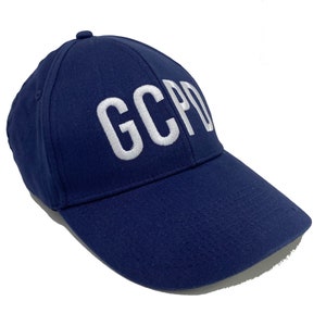 May include: A navy blue baseball cap with white embroidered text that reads "GCPD".