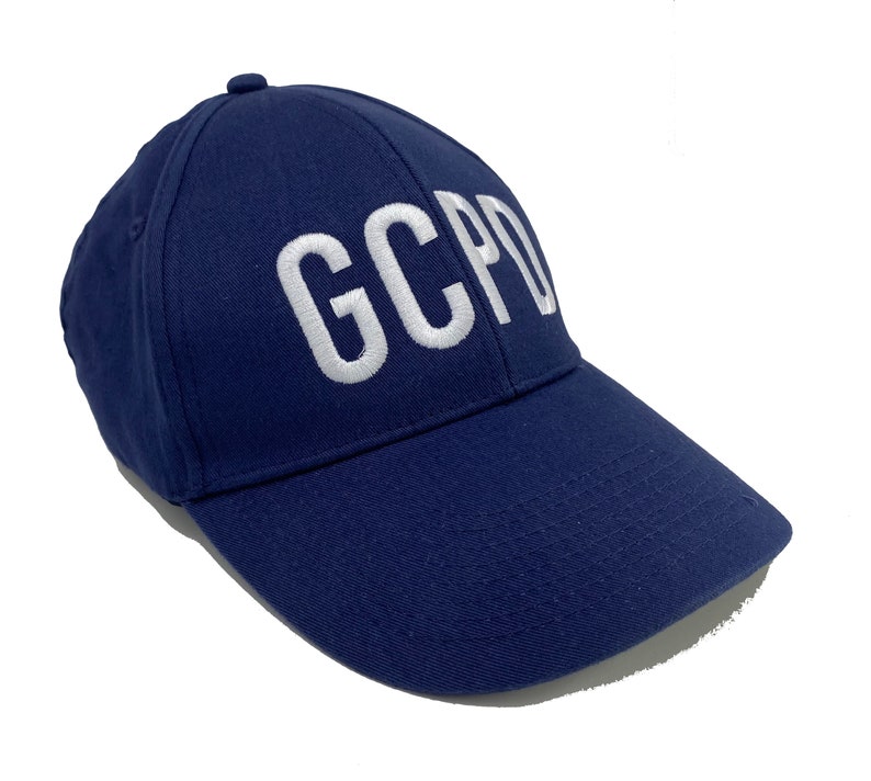 May include: A navy blue baseball cap with white embroidered text that reads "GCPD".