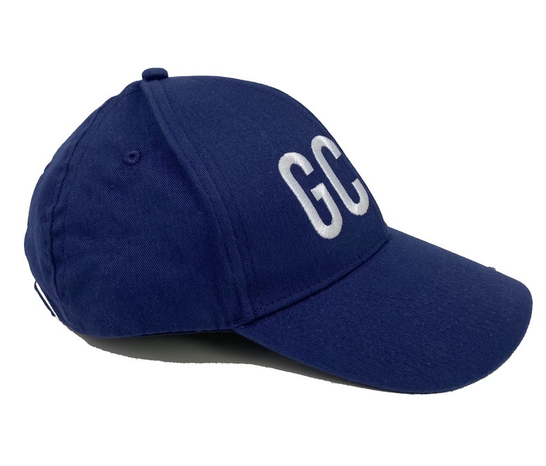 May include: A navy blue baseball cap with a white embroidered "GC" on the front.