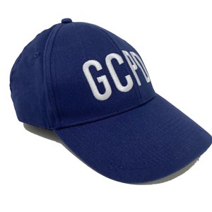 May include: A navy blue baseball cap with white embroidered text that reads "GCPD".