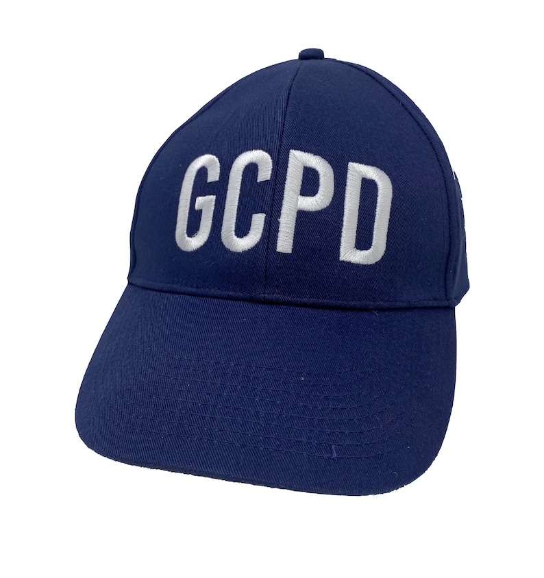 May include: A navy blue baseball cap with white embroidered text that reads "GCPD".