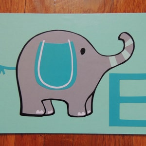 May include: A painted canvas featuring a gray elephant with a teal accent on a light teal background. The elephant has a black outline and a teal letter "E" next to it. The artwork is on a rectangular canvas.