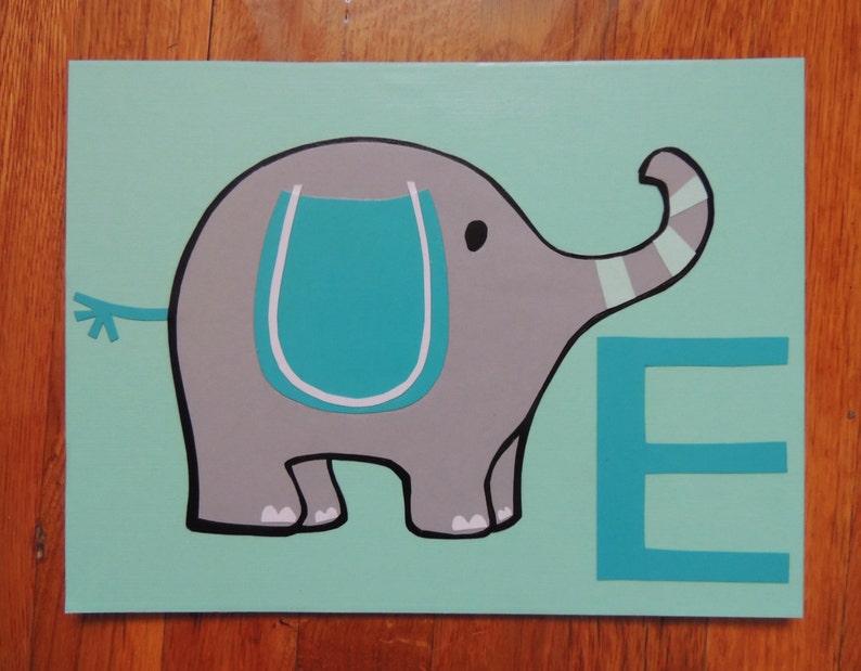May include: A painted canvas featuring a gray elephant with a teal accent on a light teal background. The elephant has a black outline and a teal letter "E" next to it. The artwork is on a rectangular canvas.
