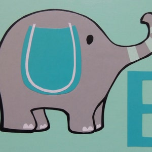 May include: A whimsical painting of a gray elephant with a turquoise saddle and the letter "E" on a light green background. The elephant has black outlines and white accents. The trunk is striped with gray and white.
