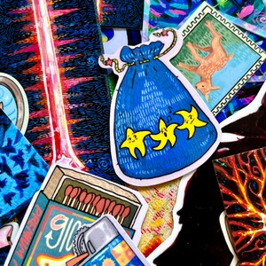 May include: A collection of colorful stickers featuring various designs, including a blue bag with stars, a matchbox with matches, a lighter, and a silhouette of a person. The stickers are on a dark background.