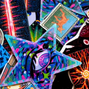 May include: A collection of colorful stickers featuring various designs, including a star with an eye, a deer, and a sword. The stickers are printed on a glossy, vinyl material and have a vibrant, psychedelic aesthetic.