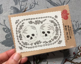 Hand-cut miniprint: deathly duet of skulls!