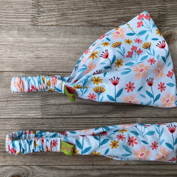 Contenu de la livraison : 1 bandeau pour enfants Fleurs rouge, jaune et rose sur bleu clair