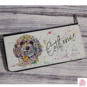 May include: A white zippered wallet with a colorful watercolor painting of a dog's face and the name "Catherine" written in black cursive.