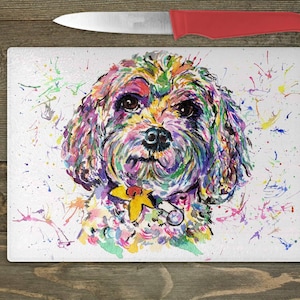 May include: A colorful watercolor painting of a dog's face on a white background. The dog has a yellow collar and a silver tag. The background is splattered with colorful paint.