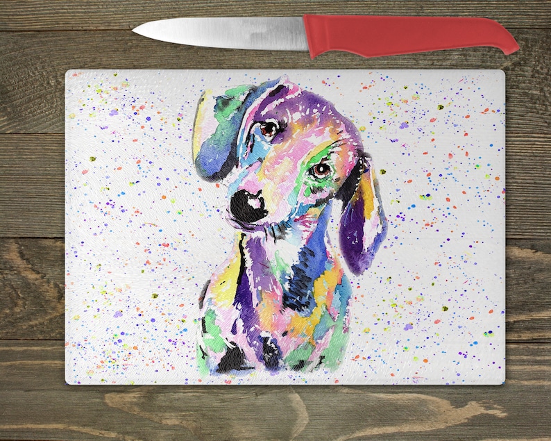 May include: A colorful watercolor painting of a dachshund dog on a white background with a splatter pattern of colorful paint.