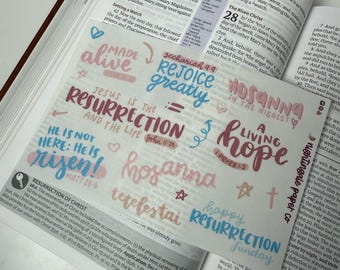 May include: A collection of colorful stickers with Christian-themed messages, including "Jesus is the Resurrection and the Life", "Hosanna in the Highest", "A Living Hope", "Rejoice Greatly", "Made Alive", "Happy Resurrection Sunday", and "He is not here: He is risen!" The stickers are printed on clear paper with a pink, blue, and white color scheme.