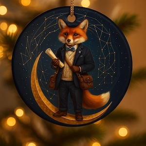 May include: A round Christmas ornament featuring a fox dressed in a suit, standing on a crescent moon. The fox holds a scroll and wears a bow tie. The background is dark blue with gold constellation lines.