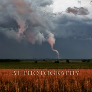 A Rope Tornado forms on the Kansas Prairie from a Rainy Day Storm Cloud into this Tornado on the Kansas Prairie in the Flint Hills of Kansas
