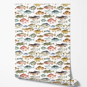 May include: A roll of wallpaper featuring a repeating pattern of various fish illustrations in shades of red, orange, blue, and green on a white background. The fish are of different sizes and species, creating a detailed and colorful design.