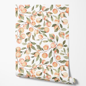 May include: Wallpaper roll featuring a repeating pattern of peaches and green leaves on a white background. The peaches are a soft orange color, and the leaves are a muted green. The wallpaper is partially unrolled, revealing the pattern.