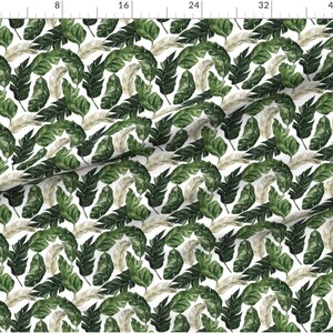 May include: A seamless pattern featuring green and beige watercolor leaves on a white background. The leaves are arranged in a repeating pattern, creating a tropical feel.