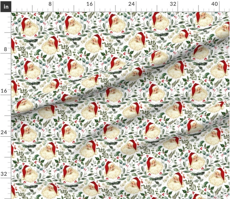 May include: A white fabric with a repeating pattern of Santa Claus faces surrounded by green leaves and red berries. The background is white.