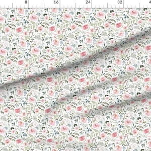 May include: White fabric with a watercolor floral pattern. The design features pink roses, blue accents, and green foliage. The pattern is repeated across the fabric, creating a delicate and romantic aesthetic.