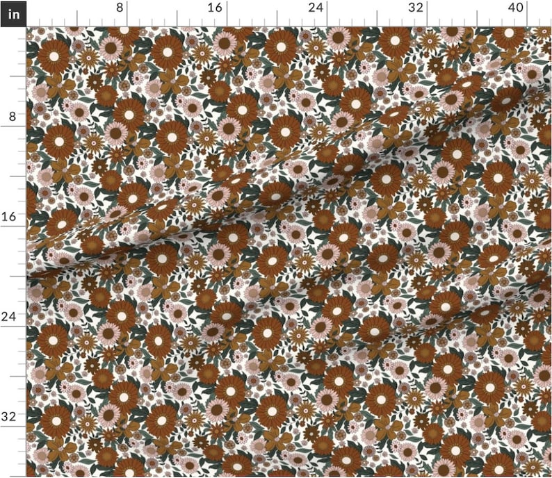 May include: A white fabric with a repeating pattern of brown, orange, and pink flowers. The flowers are arranged in a random pattern and are surrounded by green leaves.