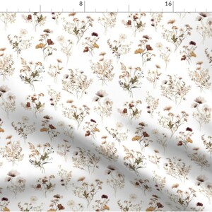 May include: A seamless pattern featuring a white background with a repeating design of brown, beige, and white wildflowers. The flowers are arranged in clusters and are scattered throughout the pattern.