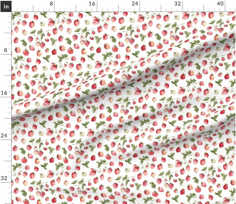 May include: A white fabric with a repeating pattern of red and green watercolor strawberries. The strawberries are scattered randomly across the fabric.