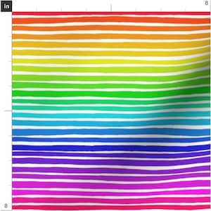 May include: A colourful rainbow stripe pattern with white stripes. The stripes are painted in a variety of colours, including red, orange, yellow, green, blue, indigo, and violet.