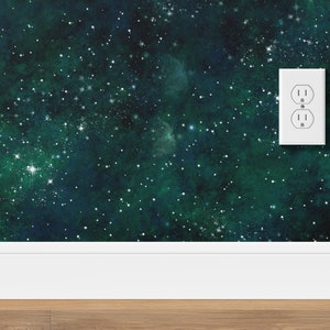 K&ouml;nnte beinhalten: Eine wei&szlig;e Steckdose vor einem dunkelgr&uuml;nen und blauen Hintergrund mit wei&szlig;en Sternen. Der Hintergrund &auml;hnelt einer Galaxie oder dem Weltraum.