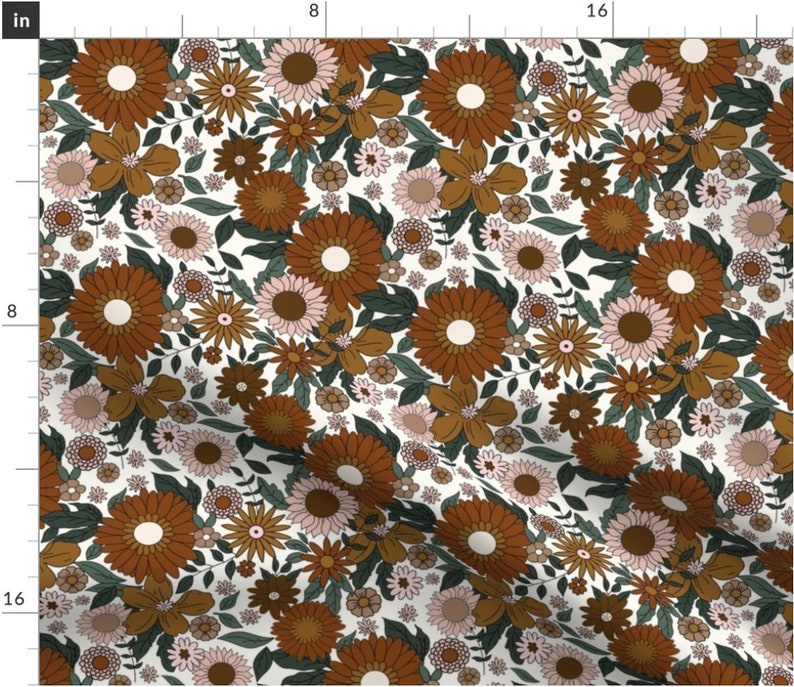 May include: A white fabric with a repeating pattern of brown, orange, and pink flowers. The flowers are stylized and have a retro 70s vibe.