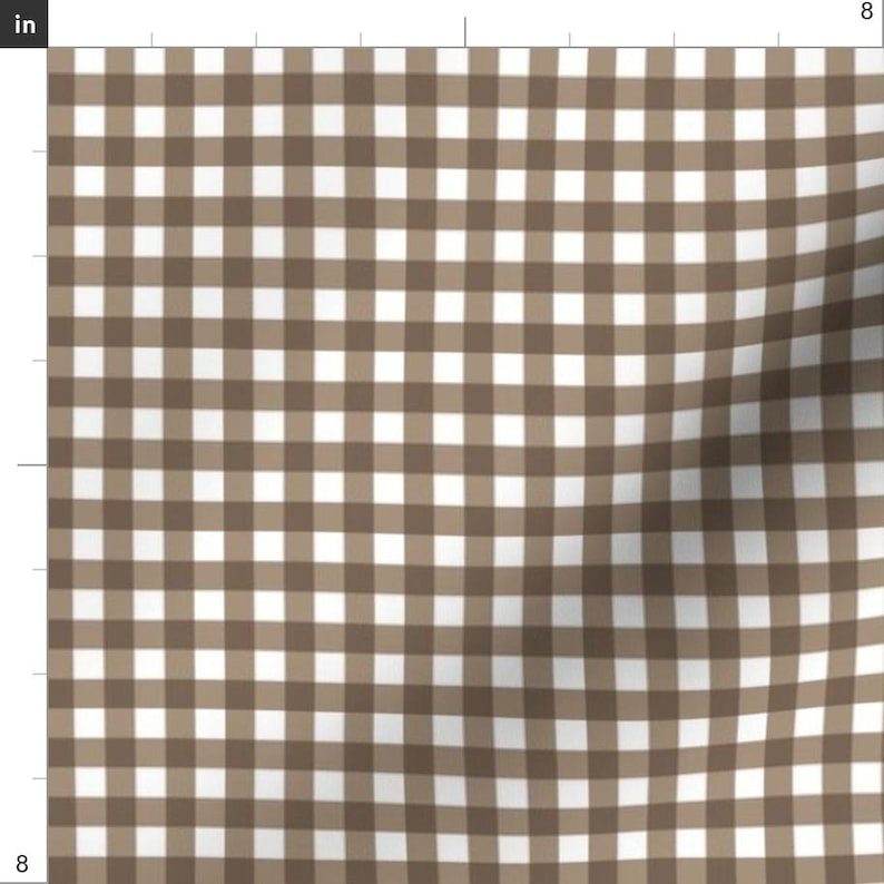 May include: A fabric with a brown and white gingham pattern. The design features a repeating grid of squares in alternating colors, creating a classic and versatile textile. The fabric is suitable for various sewing and crafting projects.