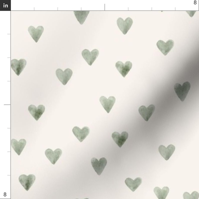 May include: Cream-colored fabric with a repeating pattern of watercolor-style sage green hearts. The hearts are evenly spaced and vary slightly in shade, creating a soft, textured appearance. The fabric is likely suitable for various craft and home decor projects.