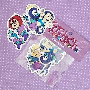 May include: A sticker pack featuring cartoon characters with red, blonde, and dark hair, in blue, purple, and green outfits. The stickers are in a clear plastic sleeve, with a purple card that reads "Witch Sticker Pack".