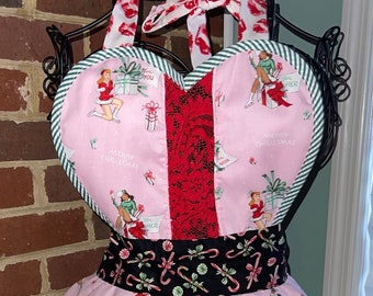 Retro apron with lace, sweetheart top and ruffles. This pink, red and black beauty will make your holiday sparkle!