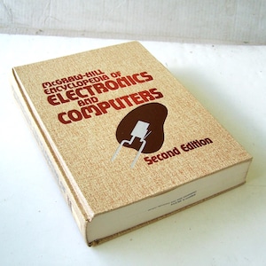 May include: A hardcover book titled "McGraw-Hill Encyclopedia of Electronics and Computers" in a tan cover with red lettering and a brown graphic. The book is a second edition.