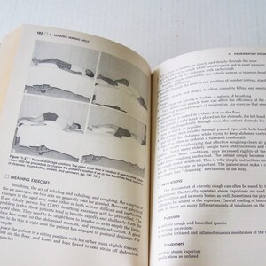 May include: Open book with text and illustrations about nursing skills. The left page shows diagrams of patients in different positions. The right page has text about breathing exercises and the respiratory system.