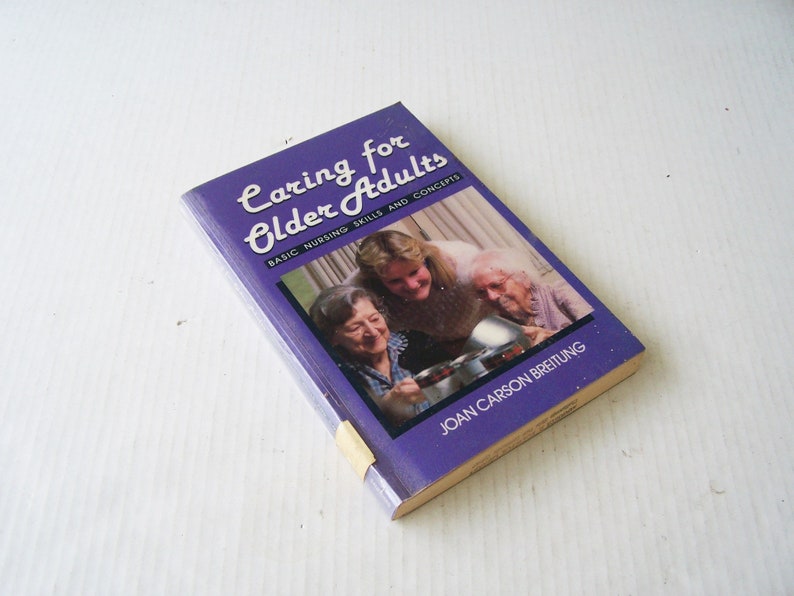 May include: A book titled "Caring for Older Adults" with the subtitle "Basic Nursing Skills and Concepts" is displayed. The cover is purple with white text and a photo of three women. The author's name, Joan Carson Breitung, is printed at the bottom.